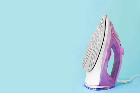 Electric iron on color backgroundの写真素材