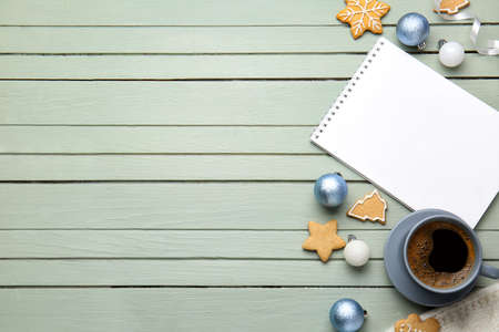 Christmas decor, notebook, coffee and cookies on wooden background