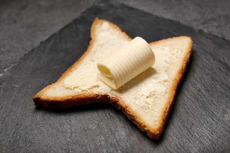 Slate plate with tasty bread and butter, closeupの写真素材