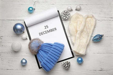 Christmas decor and calendar on wooden background