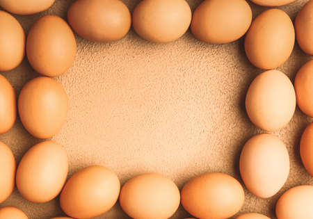 Frame made of fresh eggs on color background