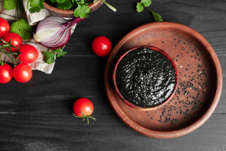 Bowl of tasty tahini on dark wooden table