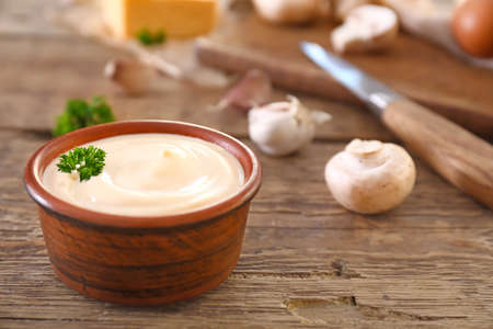 Bowl of tasty mushroom sauce on wooden tableの写真素材