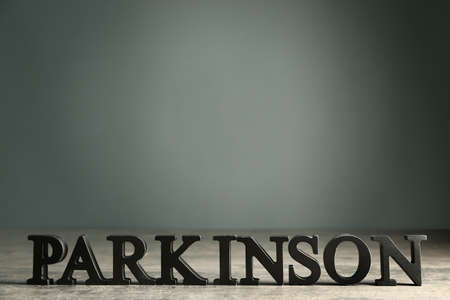 Word PARKINSON on table against dark backgroundの写真素材