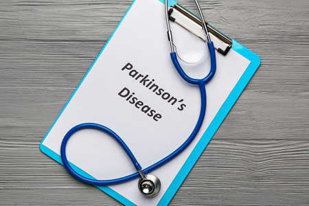 Clipboard with text PARKINSON'S DISEASE and stethoscope on wooden backgroundの写真素材