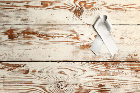 Parkinson's awareness ribbon on wooden backgroundの写真素材
