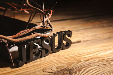 Wreath of thornes and word JESUS on wooden backgroundの写真素材
