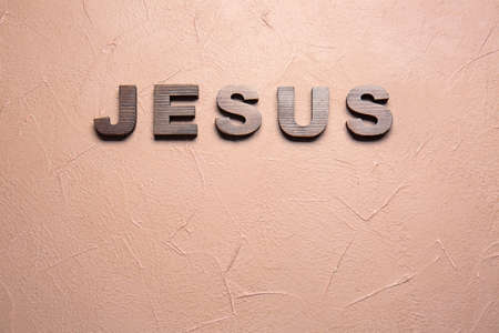 Text JESUS on color background