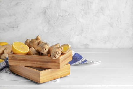 Fresh ginger with lemon on white tableの写真素材