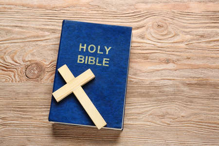 Christian cross and Bible on wooden backgroundの写真素材