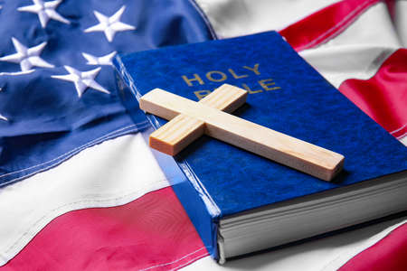 Christian cross and Bible on USA flagの写真素材