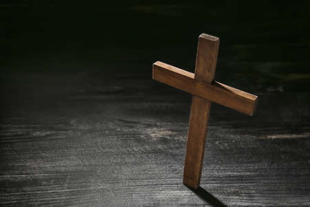 Christian cross on dark wooden backgroundの写真素材