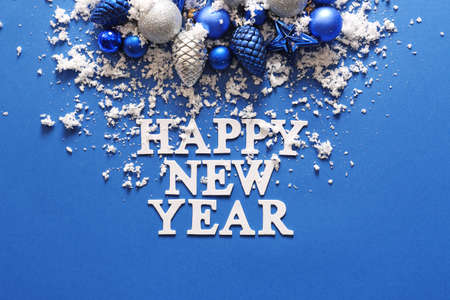 Text HAPPY NEW YEAR with decor and snow on color backgroundの写真素材