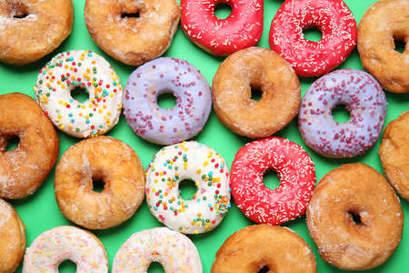 Sweet tasty donuts on color backgroundの写真素材