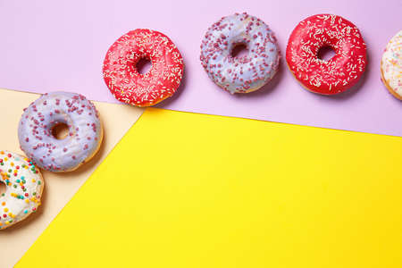 Sweet tasty donuts on color backgroundの写真素材