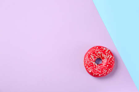 Sweet tasty donut on color backgroundの写真素材