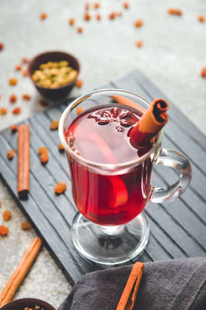 Glass cup of tasty mulled wine on table