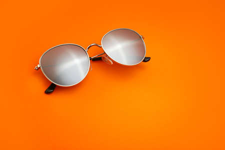 Stylish sunglasses on color backgroundの写真素材