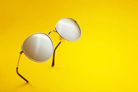 Stylish sunglasses on color backgroundの写真素材