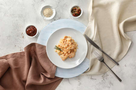 Plate with tasty rice and chicken on white backgroundの写真素材