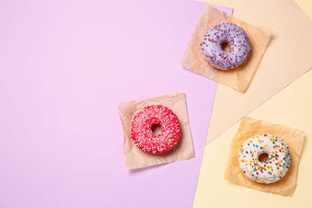 Sweet tasty donuts on color backgroundの写真素材