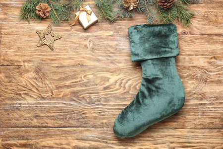 Christmas sock with decor on wooden background