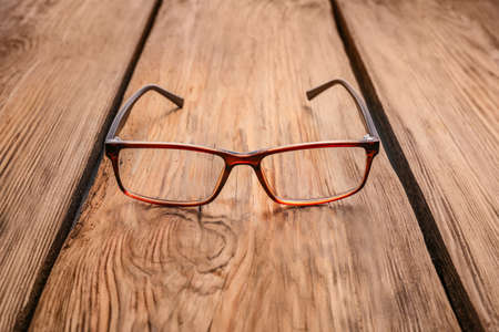 Stylish eyeglasses on wooden tableの写真素材