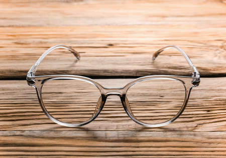 Stylish eyeglasses on wooden tableの写真素材