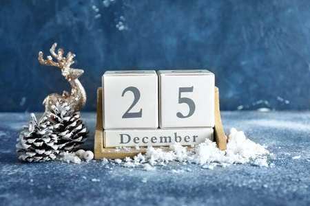 Calendar with date of Christmas and decor on table