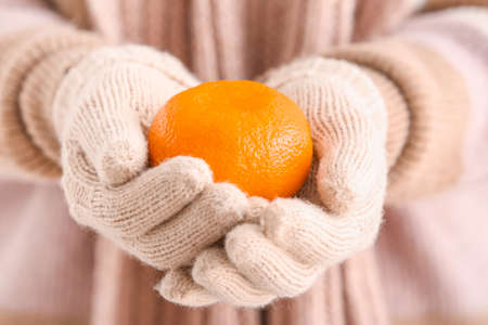 Woman with sweet tangerine, closeupの写真素材