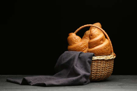 Basket with tasty croissants on dark backgroundの写真素材