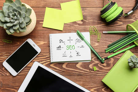Modern devices with stationery on table. Concept of SEOの写真素材