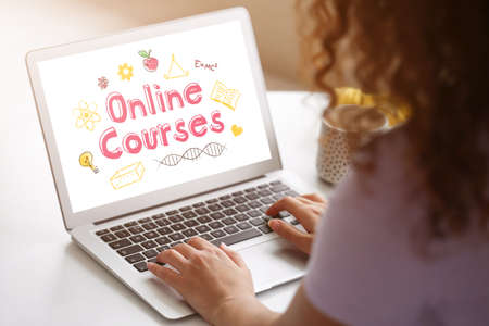Young woman using laptop for online learning at homeの写真素材