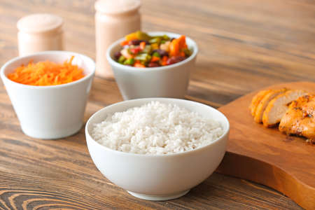 Bowl with tasty rice on tableの写真素材