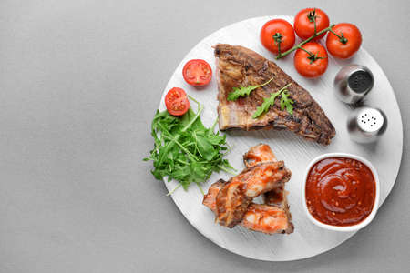 Composition with tasty barbecue sauce and meat on tableの写真素材