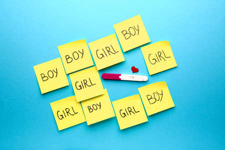 Pregnancy test and papers with text BOY and GIRL on color backgroundの写真素材