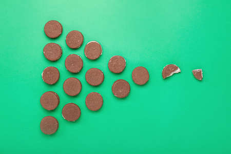 Tasty chocolate cookies on color background