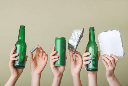 Hands with garbage on color background. Concept of recycling