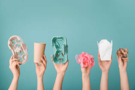 Hands with garbage on color background. Concept of recyclingの写真素材