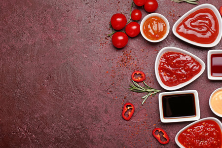 Different tasty sauces on color background
