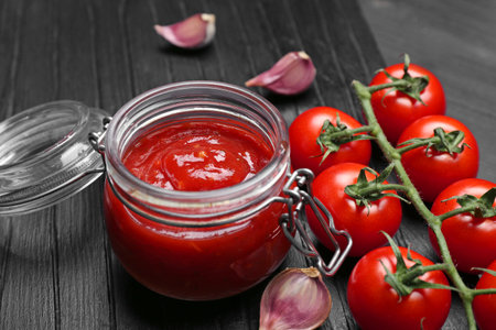 Jar with tasty tomato sauce on table, closeupの写真素材