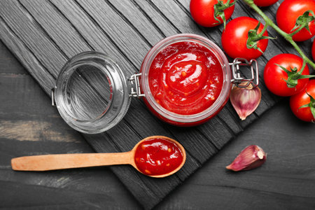 Jar with tasty tomato sauce on tableの写真素材