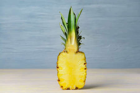Fresh cut pineapple on wooden tableの写真素材
