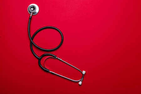 Stethoscope on color background. Cardiology concept