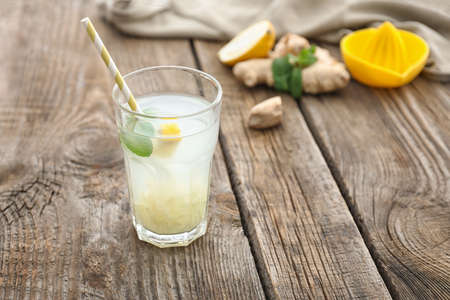 Glass of tasty ginger lemonade on tableの写真素材
