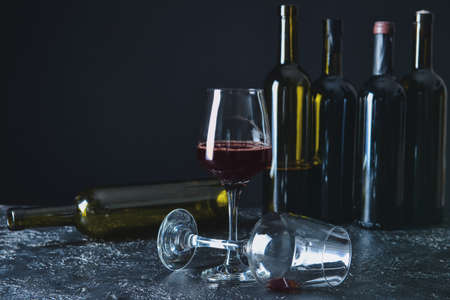 Glasses and bottles and wine on table. Concept of alcoholism