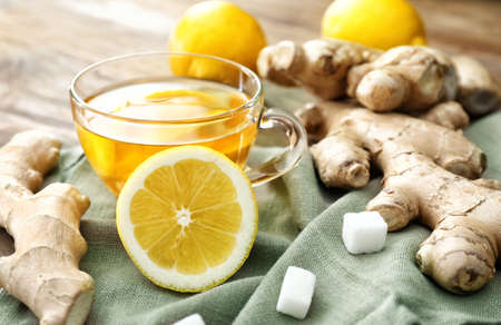 Cup of tasty ginger tea on table