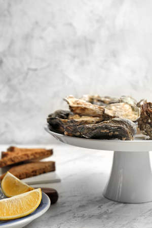 Stand with tasty oysters on tableの写真素材