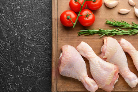 Composition with raw chicken meat on dark backgroundの写真素材