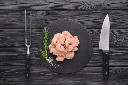 Composition with raw chicken meat on wooden backgroundの写真素材